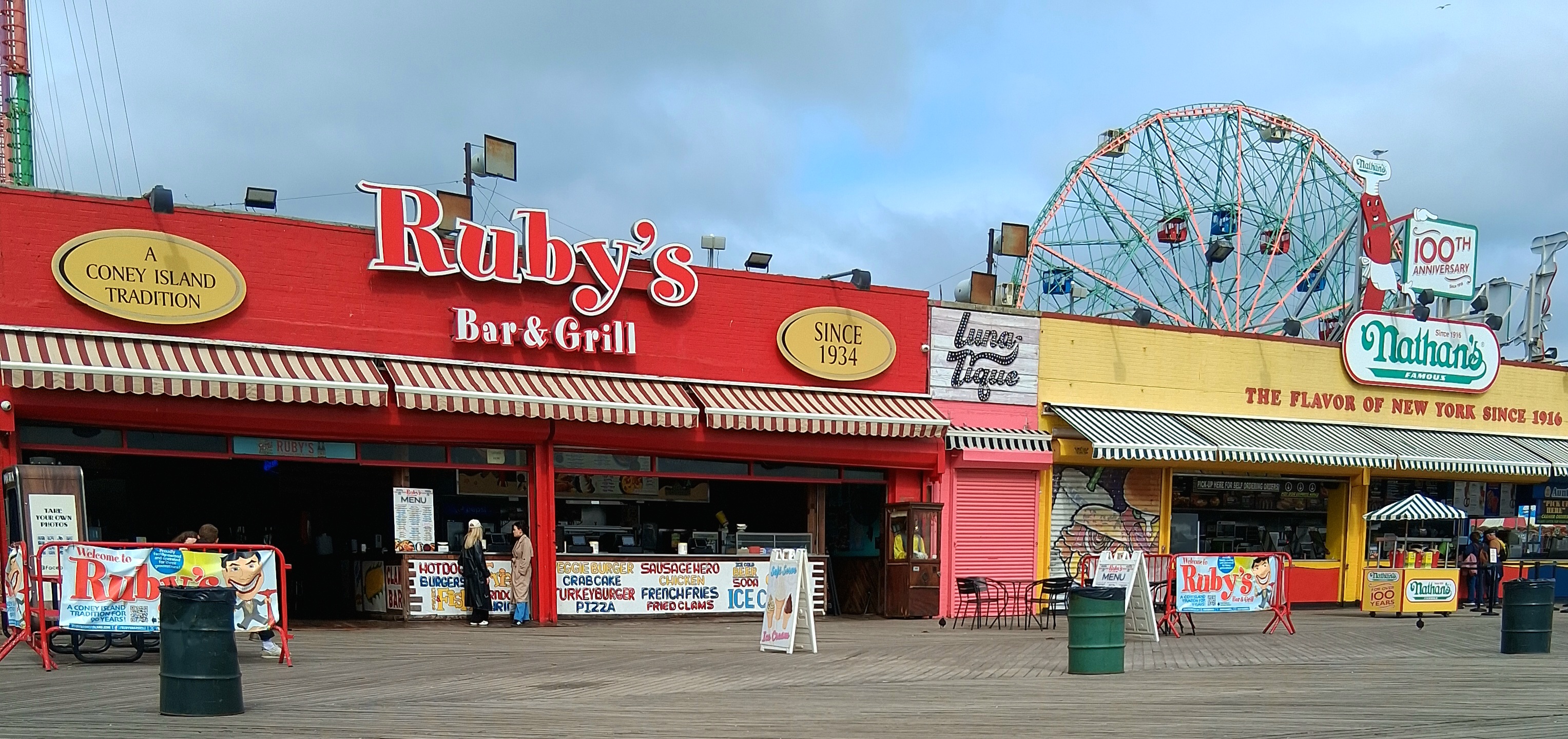 A view of the Coney Island boardwalk and amusement park at sunrise.